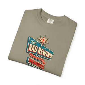 Sandstone khaki tan garment-dyed graphic tee with an ink-line retro roadside sign reading The Rad Rewind, Memories, Now Playing, Always Open, folded
