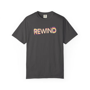 Graphite charcoal gray garment-dyed graphic tee with REWIND in retro echo-trail lettering trailing gold, pink and blue, front view