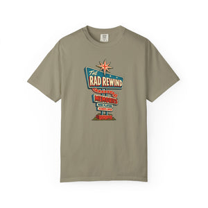 Sandstone khaki tan garment-dyed graphic tee with an ink-line retro roadside sign reading The Rad Rewind, Memories, Now Playing, Always Open, front view