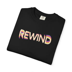 Black garment-dyed graphic tee with REWIND in retro echo-trail lettering trailing gold, pink and blue, folded