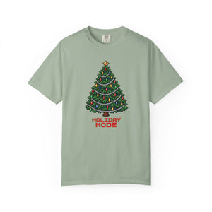 Bay sage green garment-dyed graphic tee with a pixel-art Christmas tree, colorful bulbs, silver garland and Holiday Mode lettering, front view