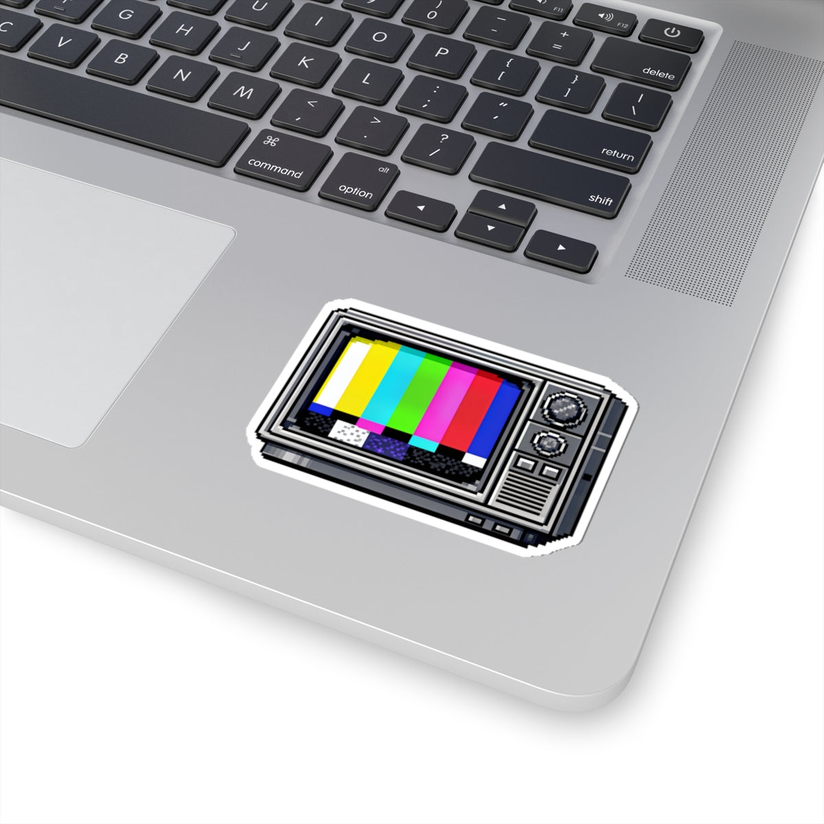 3 by 3 inch retro TV test pattern sticker applied to a laptop beside the keyboard