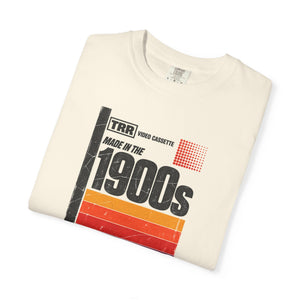 Ivory garment-dyed graphic tee with a retro cassette tape label design reading Made in the 1900s, folded