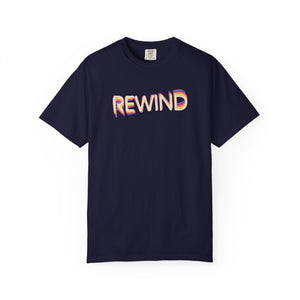 True Navy dark navy garment-dyed graphic tee with REWIND in retro echo-trail lettering trailing gold, pink and blue, front view