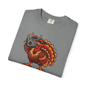 Grey medium gray garment-dyed graphic tee with a pixel-art turkey in sunglasses carrying a boombox, folded