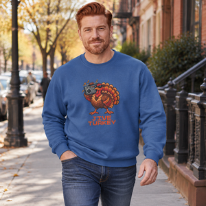 Red-haired man walking down a tree-lined city sidewalk in fall wearing a Royal Heather Jive Turkey pixel turkey sweatshirt