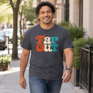 Man with curly dark hair wearing the Navy Far Out graphic tee on a sunny city sidewalk