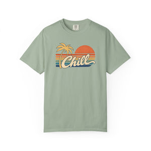 Bay sage green garment-dyed graphic tee with a retro sunset, leaning palm tree, faded stripes and cream Chill script, front view