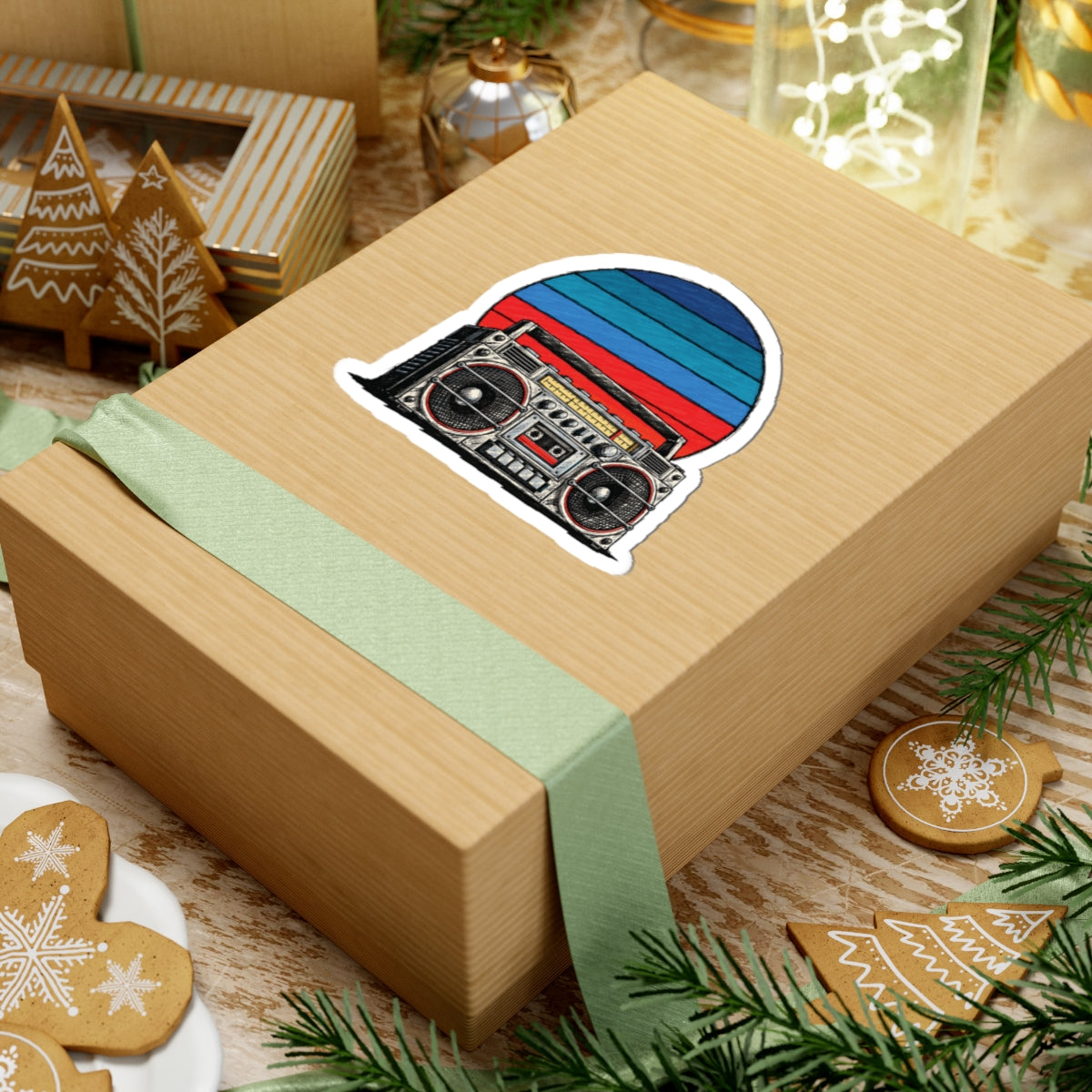 4 by 4 inch retro boombox sunset sticker applied to a kraft gift box among holiday decorations