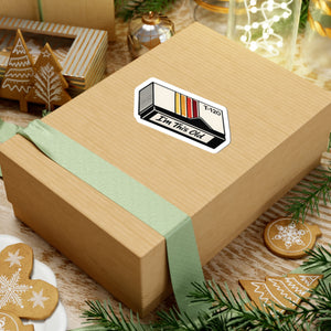 4 by 4 inch I'm This Old retro VHS cassette sticker applied to a kraft gift box among holiday decorations
