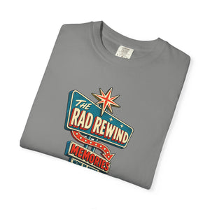 Granite gray garment-dyed graphic tee with an ink-line retro roadside sign reading The Rad Rewind, Memories, Now Playing, Always Open, folded