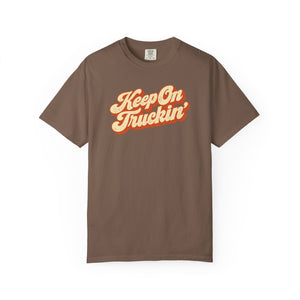Espresso brown garment-dyed graphic tee with Keep On Truckin' in leaning cream script and a burnt-orange shadow, front view