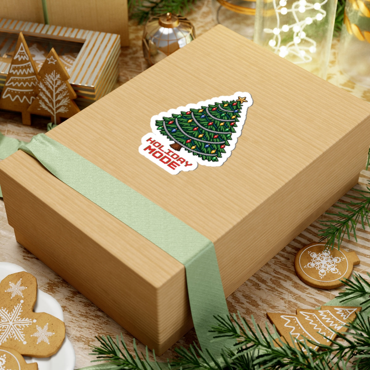 4 by 4 inch Holiday Mode pixel Christmas tree sticker applied to a kraft gift box among holiday decorations