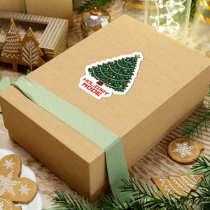 4 by 4 inch Holiday Mode pixel Christmas tree sticker applied to a kraft gift box among holiday decorations