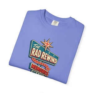 Flo Blue periwinkle garment-dyed graphic tee with an ink-line retro roadside sign reading The Rad Rewind, Memories, Now Playing, Always Open, folded