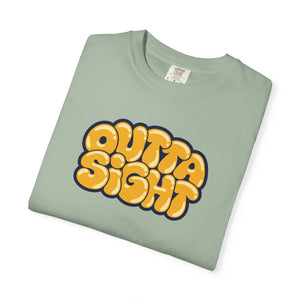 Bay pale sage green garment-dyed graphic tee with Outta Sight in puffy golden bubble letters, cream highlights and a navy outline, folded