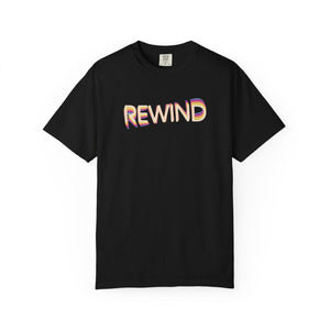 Black garment-dyed graphic tee with REWIND in retro echo-trail lettering trailing gold, pink and blue, front view