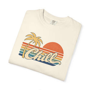 Ivory cream garment-dyed graphic tee with a retro sunset, leaning palm tree, faded stripes and cream Chill script, folded