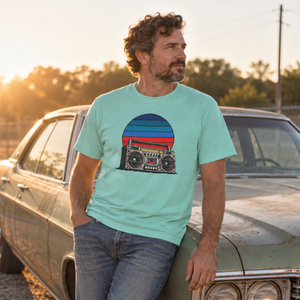 Retro boombox sunset tee in mint worn by a man leaning on a classic car at golden hour — The Rad Rewind